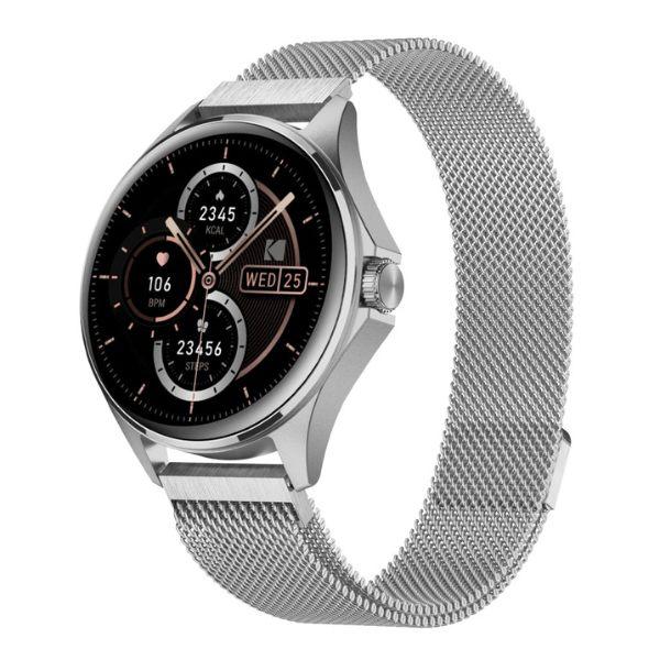 El Reloj Smart Watch SW-7212 de Kodak es un reloj inteligente con muchas funciones, incluyendo:

Pantalla:
- Pantalla táctil HD de 1.32"
- Resolución de 466 x 466 píxeles

Seguimiento de Salud y Estado Físico:
- Monitoreo de salud 24/7 (Frecuencia Cardíaca, Oxígeno en Sangre - SpO2, Presión Arterial, Prueba de Estrés)
- Más de 100 modos deportivos con seguimiento de movimiento a través del GPS del móvil
- Podómetro
- Monitoreo del sueño

Funciones Inteligentes:
- Llamadas por Bluetooth y soporte de Asistente de Voz (BT 5.0 + BT 3.0)
- Notificaciones de Mensajes
- Control de Cámara
- Control de Música
- Función "Encontrar Teléfono"
- Reloj Mundial, Alarma, Cronómetro, Temporizador
- Actualizaciones del Clima
- Calculadora, Calendario, Recordatorios
- Firmware multi-idioma
- Múltiples carátulas de reloj (10 preinstaladas + opciones personalizables)

Diseño y Construcción:
- Botón de navegación con corona giratoria
- Material de la Caja: Aleación de Zinc
- Material de la Correa: Acero Inoxidable
- Resistencia al Agua: IP67

Batería:
- Capacidad de la batería: 260mAh
- Tiempo de funcionamiento: Hasta 5 días
- Tiempo en espera: Aproximadamente 10 días
- Tiempo de carga: Alrededor de 3 horas
- Método de carga: Carga Inalámbrica / Carga Magnética

Conectividad y Compatibilidad:
- Bluetooth: BT 5.0 + BT 3.0
- Compatible con Android e iOS

Otras Funciones:
- Micrófono y Altavoz Incorporados
- GPS (a través del móvil)

En la Caja:
- Kodak Smartwatch SW-7212
- Base de carga
- Paño de limpieza
- Manual de usuario